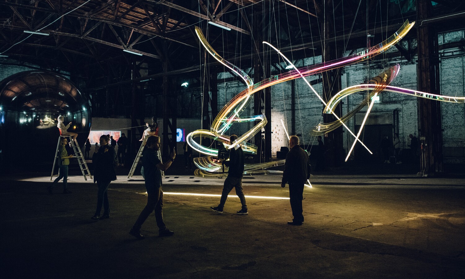 Light installation with visitors at the Industrial hall